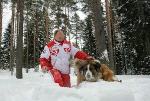 Vladimir Putin in the snow with a dog.