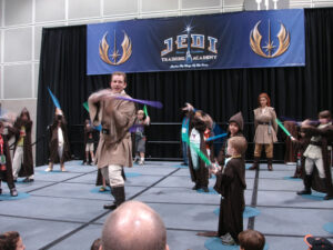 A group of people in Star Wars costumes at a Jedi training academy.