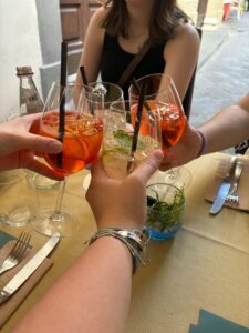A group of friends clinking their drinks together.