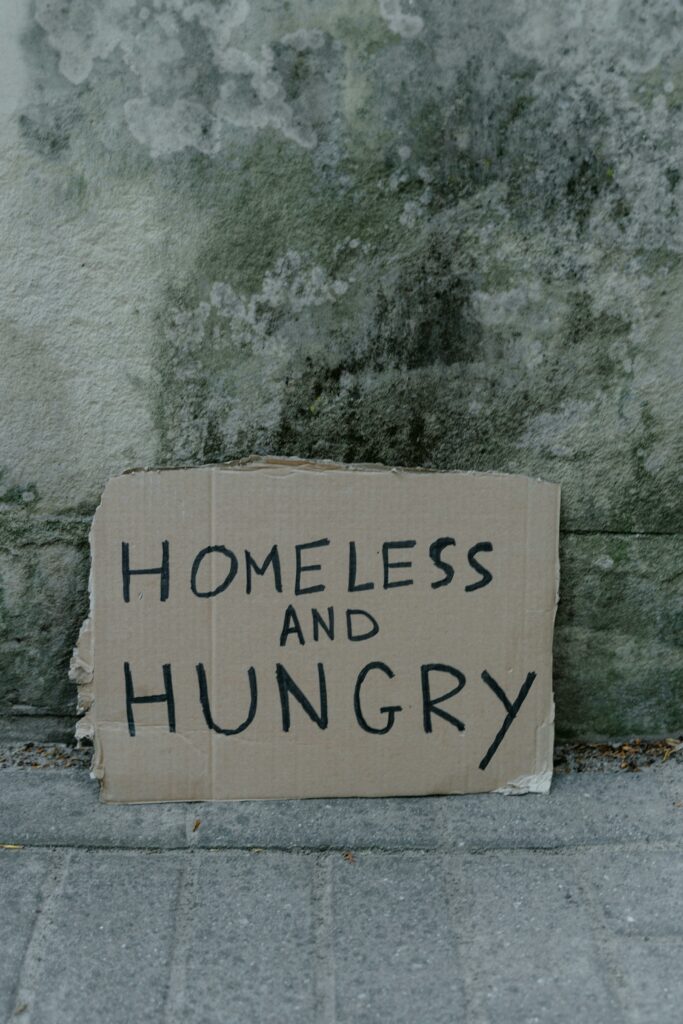 A cardboard sign that says "Homeless and hungry."