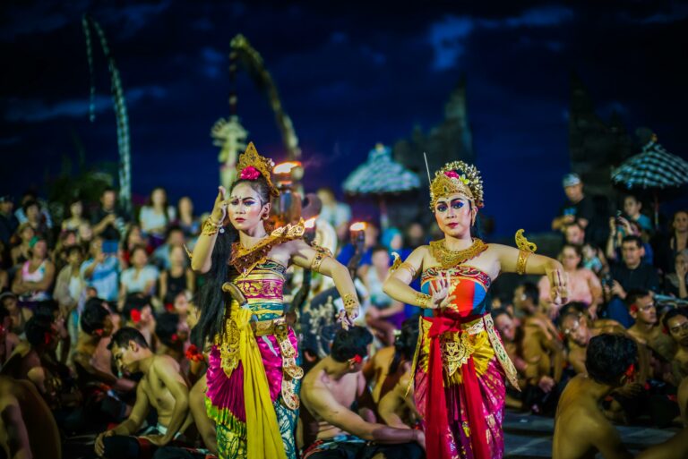 Two Indonesian female dancers performing in a crowd.