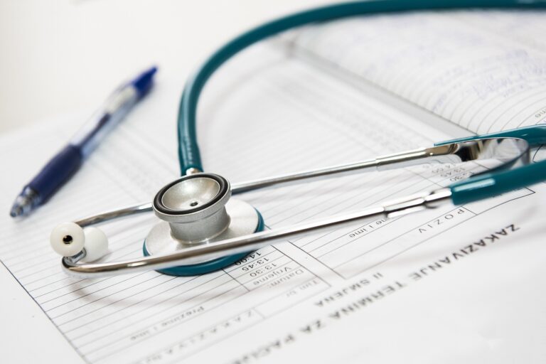 A doctor's stethoscope laying on top of documents.
