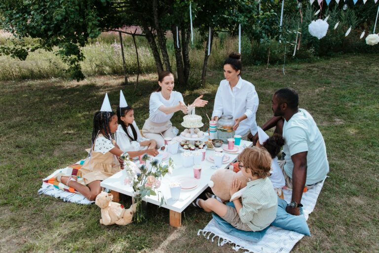 A family and children having a birthday party outside.