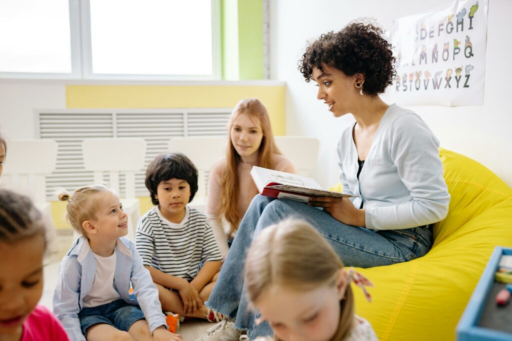 An elementary school teacher reading to children in class.