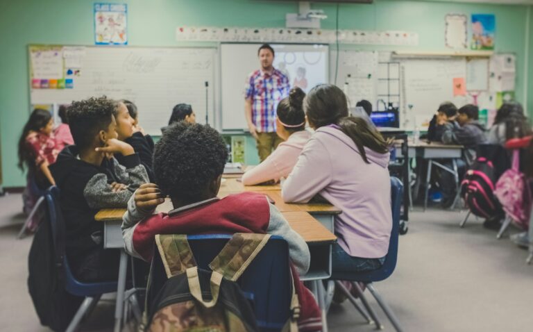 A group of young students sitting in a school classroom.